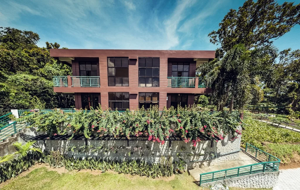 Golden Sunset building with a landscaped garden and mature trees