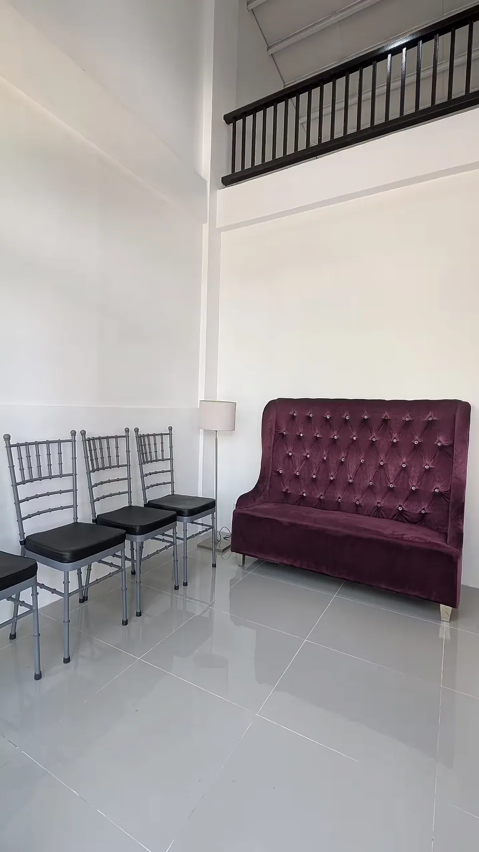 Guest house sleeping area with an upholstered headboard and chairs