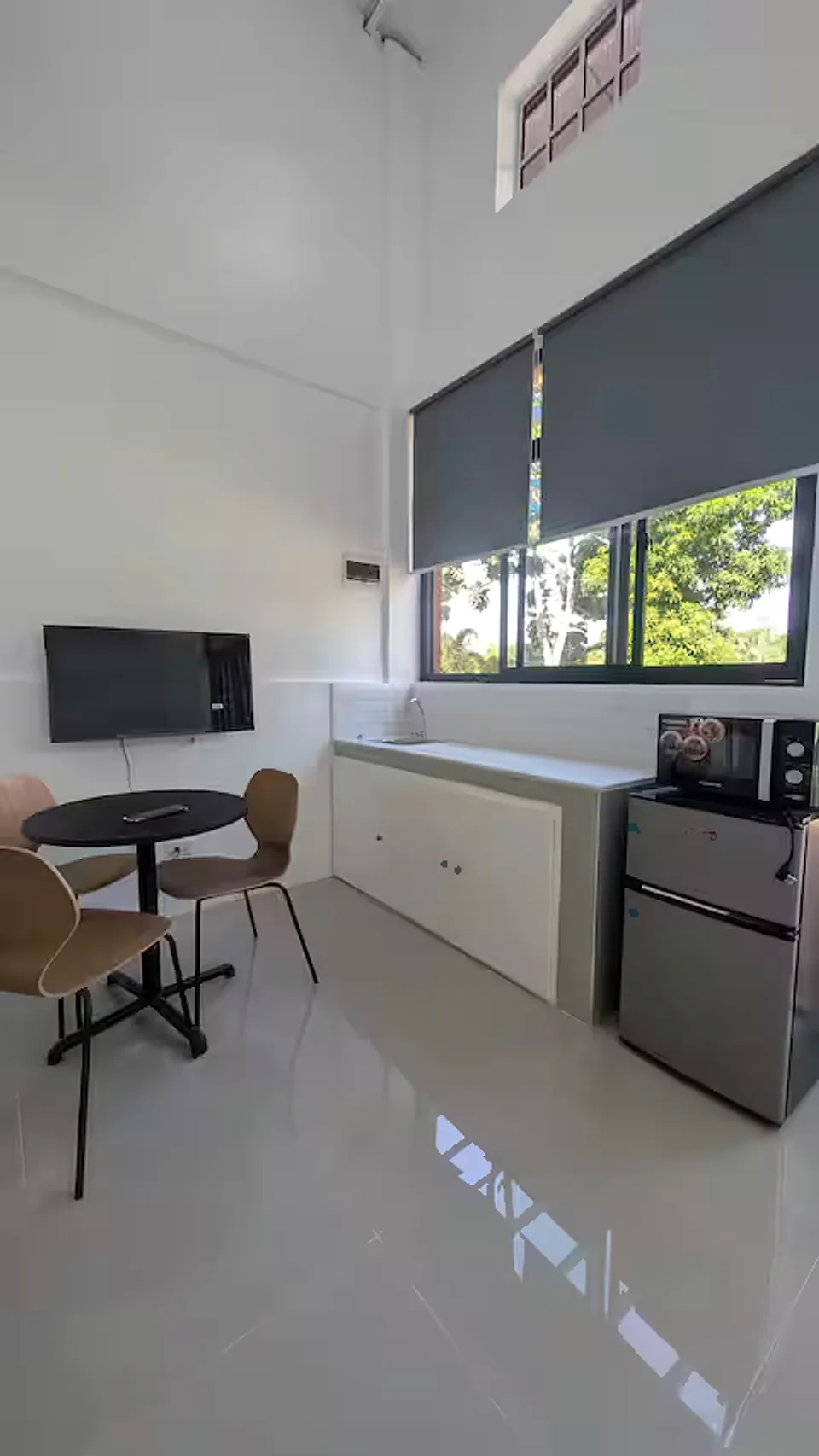 Compact dining area and kitchenette with large garden windows