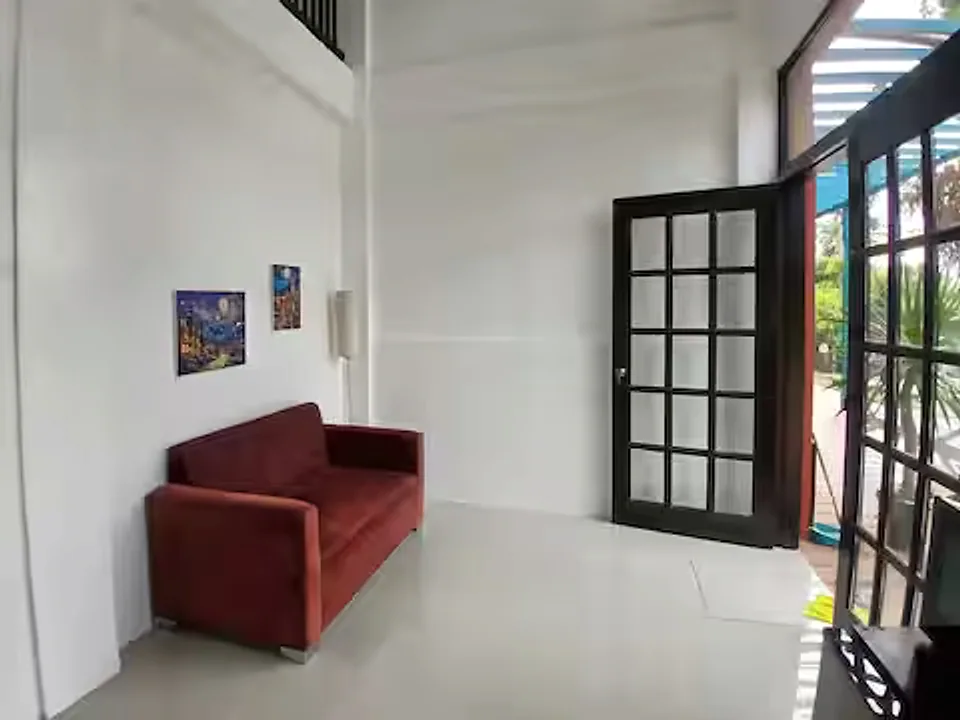 Guest house lounge with a sofa and glass garden doors