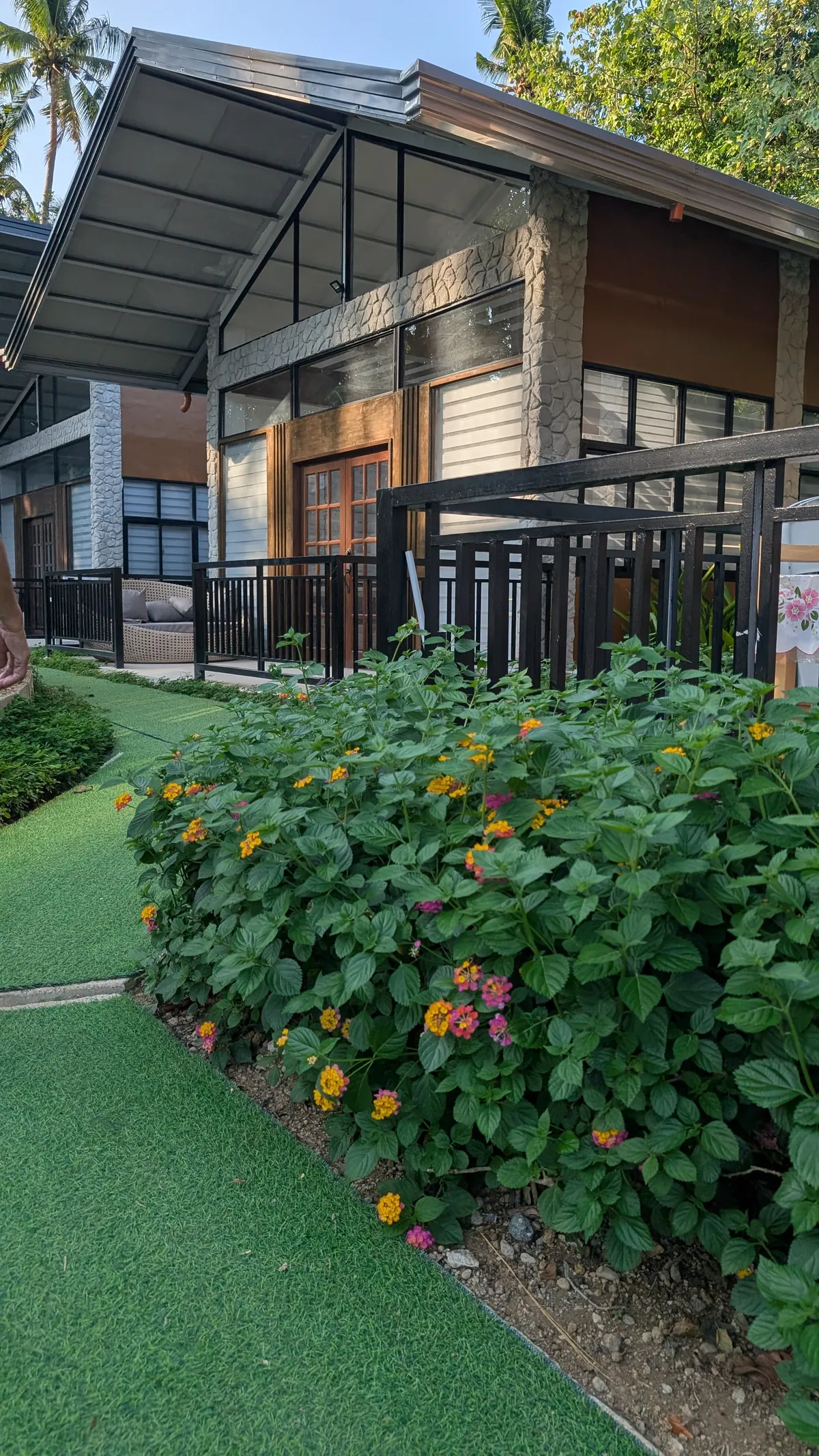 Tiny house exterior with a private covered porch and surrounding greenery